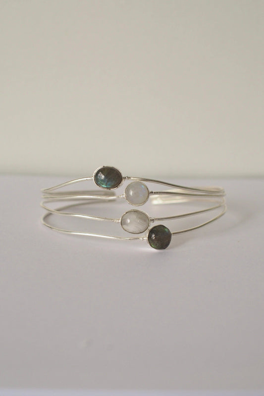 Silver ocean bangle with three gemstones on a white background